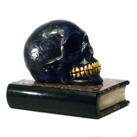 paper weight, scull on book
